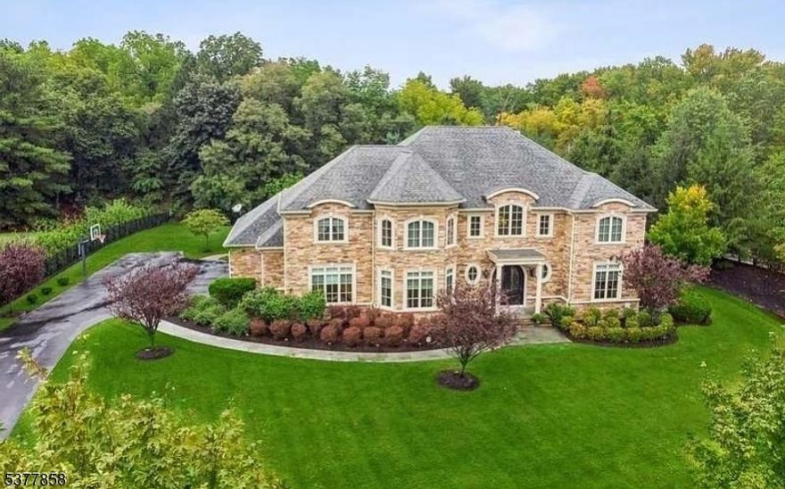 Where luxury meets privacy, set on a serene 1.5-acre lot at the end of a quiet street, this stunning estate offers over 5,000 sq. ft. of thoughtfully designed living space with 6 spacious bedrooms and 6 full bathrooms, with two of them on the first level, for large households or those who love to entertain. Enjoy peace and seclusion with township-owned land both in front and behind the property, plus scenic preserved farmland in the vicinity. The stone and stucco facade, complemented by durable vinyl siding, delivers a striking curb appeal. Inside, 10-foot ceilings, engineered hardwood floors, and an open, light-filled layout set the tone for elegance and comfort. The chef's kitchen boasts high-end appliances, a large island with a sink, a butler's pantry, an additional walk-in pantry/multi-purpose room, and a bright breakfast nook. The Great Room's wet bar makes hosting a breeze. All bedrooms feature generous closet space, while the luxurious master suite offers his-and-her walk-in closets for the ultimate in convenience and style. Upstairs, spacious bedrooms are complemented by a convenient laundry facility on the second floor. The 9-foot ceiling walkout basement with a rough-in for a future bathroom offers endless possibilities for customization. A 3-car garage, large deck overlooking the private backyard, Andersen 400 windows, and Lennox 2-zone HVAC complete this exceptional home. A rare blend of luxury, privacy, and natural beauty, your forever home awaits.