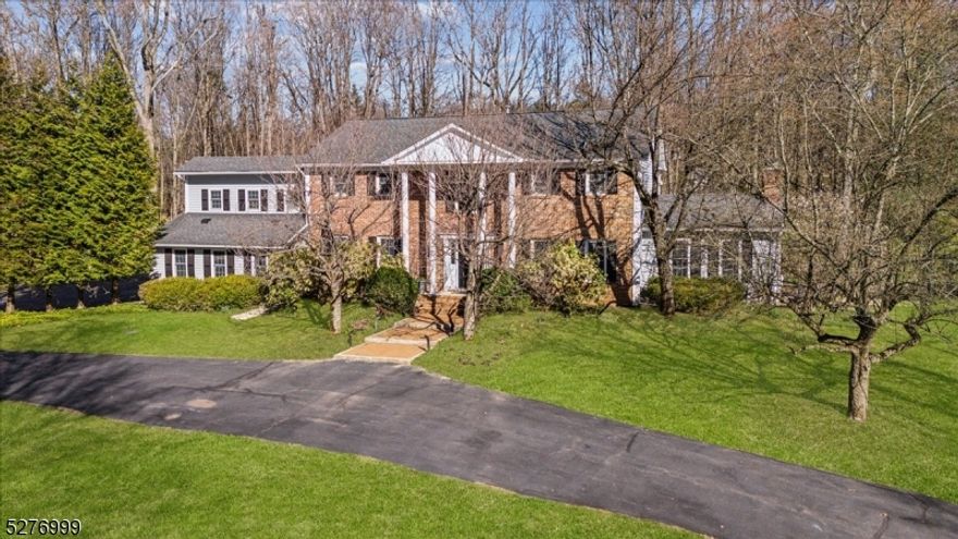 Stately 4,000+sqft brick Colonial on 5 wooded acres. Features 4 generously sized BD, 3FB, 2HB, sunny family room, cozy library/den, large living room, gourmet kitchen w/breakfast area &wet bar, dedicated dining room & sprawling outdoor oasis. Column-flanked front entry ushers you to 1st level w/rich hardwood floors, crown molding, recessed lighting. Formal living room w/French doors to library/den w/vaulted ceiling, wood paneling & fireplace. Dining room w/wainscoting. Gourmet kitchen equipped w/rich wood cabinetry, dual dishwashers, oversized island, pizza oven & skylight. Family room w/vaulted ceiling, floor-to-ceiling stone fireplace & open vistas. Completing 1st level: laundry room, mudroom, attached 2car garage&2 powder rooms. 2-story foyer w/curved stairwell takes you to 2nd floor. Primary suite w/tray ceiling, 3 closets & private balcony, en-suite w/separate tub & shower & skylight. 2 additional bedrooms share full hall bath, 4th bedroom has en-suite/tub + staircase to 1st floor. Bonus room completes this floor. Outdoor Haven offers a sparkling in-ground pool w/new heater & pump, koi pond & renovated tennis court. 2 sheds (1 w/12V solar) Extra Amenities: electric car charger, Rachio in-ground sprinkler system, 3 zone central AC, house generator, radiant heated floors in living room & kitchen, Sonos sound, security system, roof w/3 snowmelt areas. Excellent location surrounded by parkland & top-rated schools, shopping & dining in Mendham & Chester + NYC transit.