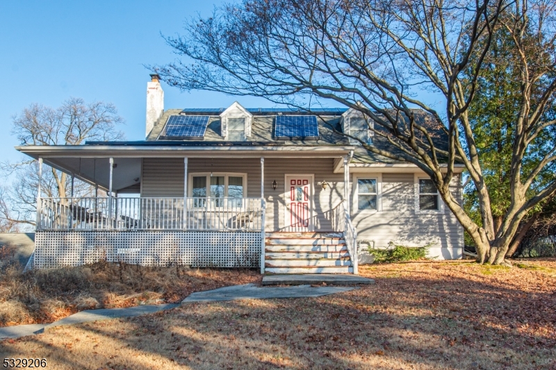 This 5-bedroom, 3-bath Colonial combines timeless charm with endless potential on nearly an acre of property. Set far back from the road, the home offers extra privacy and a long driveway that adds to its grand appeal. Enjoy a wrap-around covered front porch, solar panels, and two decks overlooking a backyard oasis with an in-ground pool, hot tub, and sauna perfect for entertaining. The interior features a spacious layout ready for your modern touch, including a partially finished walk-out basement that offers flexible living space. With a 1-car attached garage and a 2-car detached garage with loft storage, there's ample room for vehicles, storage, and hobbies. This home offers privacy, potential, and endless possibilities for your personal touch!