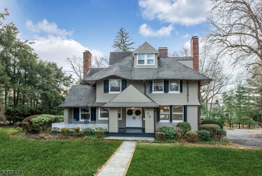 This newly renovated, timeless Colonial in desirable Ridgewood Heights sits beautifully on over one acre. The welcoming front porch leads to a dramatic entry, revealing a spacious living area with a fireplace and grand staircase. The bright, eat-in kitchen, complete with a functional butlery and coffee bar, flows into a sunlit family room with built-ins, all opening to a terrace overlooking lush grounds. Upstairs, find new hardwood floors with 4 bedrooms, including a large primary suite with fireplace & dual walk-in closets & a back staircase to the kitchen. The 3rd floor hosts a private ensuite bedroom with an alcove. The lower level caters to diverse activities, with a craft room, office, mudroom, laundry, gym, and garage access. Additionally, a detached 2-car garage with a loft offers extra space. Minutes from the commuter train and a vibrant town center with fine dining and shopping, this home is a perfect blend of comfort & convenience.
