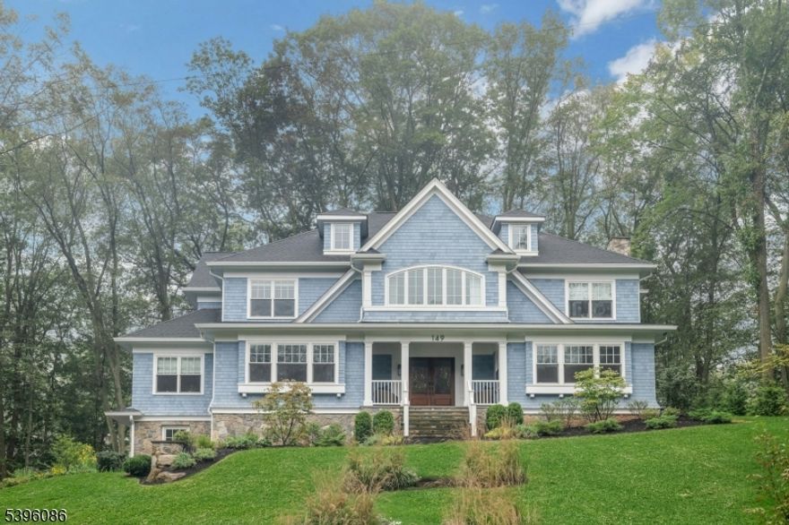 Custom Colonial Revival on the North Side of Summit. Set on .64 beautifully landscaped acres, this custom Colonial Revival was designed by KimTone of TLA Design and built by Cardone Contracting. Blending timeless architecture with modern comfort, the home offers seven bedrooms and seven and a half baths, each with its own en suite bathroom.  The main level features a gracious foyer, formal living and dining rooms, a first floor study, and a chef's kitchen that opens to a spacious family room. French doors lead to a custom bluestone patio and outdoor kitchen with a 42 inch Alfresco grill, custom steel cabinetry, and ample storage, perfect for entertaining. The primary suite is a private retreat with his and her closets, remote controlled drapery, and an oversized walk in shower. The third floor offers a comfortable sitting room, while the lower level includes a mudroom, exercise room, recreation room with wet bar, an additional bedroom, and direct access to the three car attached garage.  This exceptional property combines classic design, modern luxury, and a prime North Side location, just minutes from downtown Summit, top rated schools, and NYC transportation.