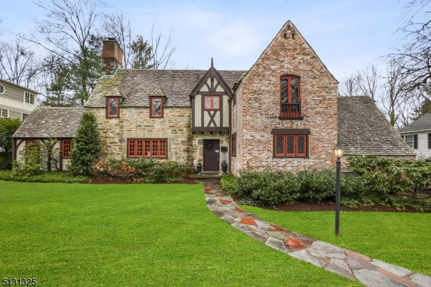 Stunning curb appeal is just the start to this beautiful one of a kind stone/brick French Norman Tudor, believed to be the 1st home built in Woodland Park, set on nearly 1/2 acre of level property steps to Franklin Elem. School.  A  wonderful floorplan offers elegant formal rooms and comfortable day-to-day living spaces.  Extensively renovated w/ a 3-story award winning addition in 2009 by The Rosen Group, Old World charm was seamlessly blended w/ modern living spaces.  Expert craftsmanship includes pretty millwork, peaked doors, diamond paned windows, plaster walls, built-ins, wood flrs, beamed/vaulted ceilings, slate roof & 4 FP's.  A large LR w/FP is adjac. to a 1st OFC w/rad. heated flrs. Also on 1st, FDR & Fam Rm w/PR.  Custom EIK has a FP, cent. island, top-of-the-line appls (incl. a Lacanche gas range) & a generous Break. Area w/access to a priv. patio & backyard.  A LUXE Primary Suite w/FP has high ceilings, a charming Juliette balcony, 2 WICs & a spa-like Bath w/steam shower & rad. heated floors.  4 addt'l BRs (2 en suite) & 4 Full BAs on 2nd incl. a sep. aupair/guest suite.  Direct entry from the gar. & driveway lead to a Mud Rm w/ample closets/cubbies.  The LL, also part of the reno., has a spacious Rec Rm w/FP, great nat. light, high ceilings, a Ldry area, PR, wine cellar & stor/utility rms.  A charming, orig. storage shed is primed for a poss. outdoor bar/game rm/potting shed.  This home is truly a rare offering in one of Summit's most sought-after neighborhoods!