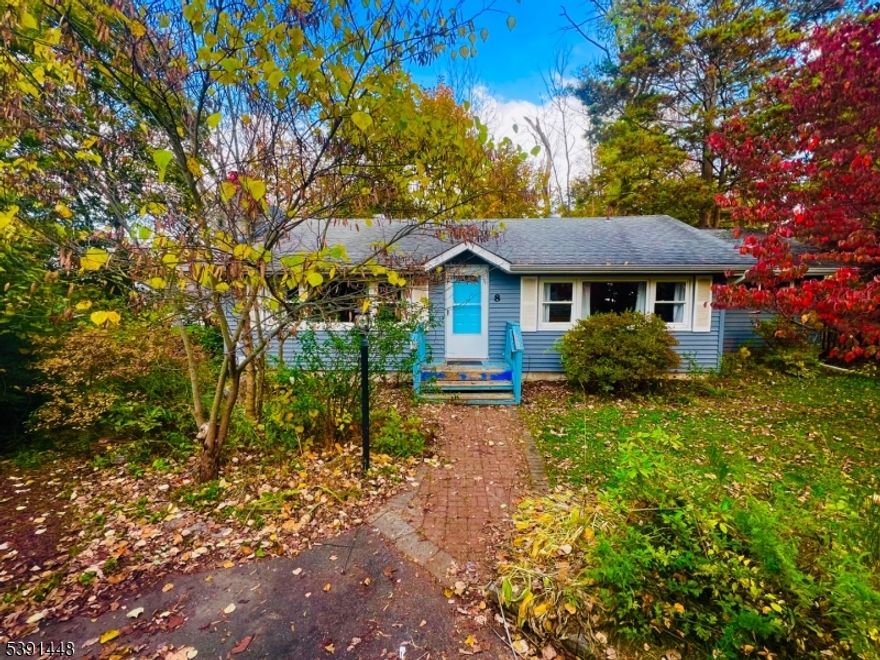 HUGE PRICE DROP. 3 Bedroom 1 Bath Ranch home on a quiet cul-de-sac. The property speaks of nature, with tall trees, gardens, and vines, beautiful flowering trees and plants. Step inside to find beautiful original hardwood floors, beam ceilings, and abundant natural light streaming through the skylight window. The cozy stone fireplace creates a warm, inviting atmosphere year-round. The eat in kitchen is tiled, with wood cabinets, plenty of counter space and perfect for entertaining. unwind on the deck overlooking your yard, where you'll find space to relax, entertain, or explore nature.  The property offers privacy, charm, and convenience. Seller can do quick closing. Listing is being SOLD "AS IS"  - Seller Disclosure Avail.Please do due diligence for Lake Tamarack, by laws, annual fees, dues, one time fee.