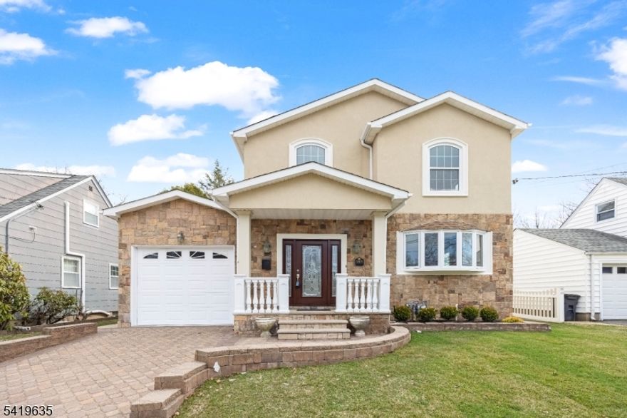 Welcome to this beautifully crafted 4-bedroom, 2.5-bath Colonial on a prestigious block in Clifton, NJ, rebuilt as new construction on the original foundation in 2007 a total of approx 3300sqft of living space and offering a perfect blend of classic elegance and modern comfort. The exterior ft an attractive stucco and stone facade with vinyl siding and oversized windows, gleaming hardwood floors, high ceilings, central air, forced hot air, and energy-efficient solar panels. The 1st floor offers an inviting foyer with 2 coat closets, a home office with bay window, spacious living room, tiled dining room, and an eat-in gourmet kitchen with custom cabinetry, granite countertops, ss appliances, and a large center island, plus 2 French doors leading to a Trex deck ideal for entertaining, a bedroom with two closets, and an elegant powder room. Upstairs ft an expansive primary suite with a huge walk-in closet, private balcony, and luxurious bath with double vanity, Jacuzzi tub, and jetted shower, along with 2 large bedrooms with double closets and a full bath with jetted tub. The full finished basement offers high ceilings and a dedicated laundry room, fully fenced backyard includes a patio, built-in shed, and sprinkler system. Additional highlights include a paver driveway, attached garage, and an unbeatable location minutes to major highways, steps to NYC bus transportation, close to train, shopping, country club, schools, parks, and houses of worship. Truly a must-see home!