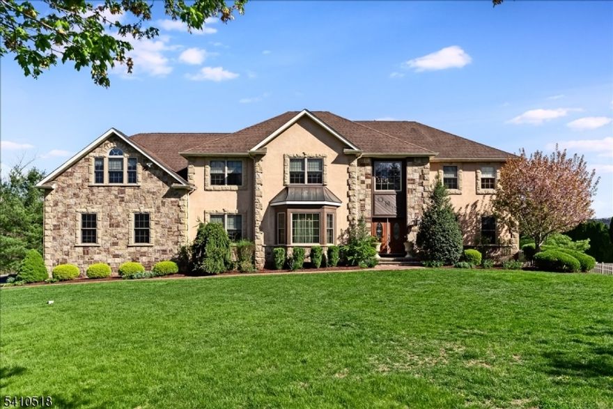 Welcome to this exceptional 5-bedroom, 4.5-bath Colonial set on a quiet cul-de-sac in highly sought-after Denville. Perfectly positioned on a flat, manicured property, this home offers a refined blend of timeless design and modern comfort. A grand two-story foyer with soaring ceilings sets the tone, leading to sun-drenched living and dining spaces enhanced by rich wood flooring. The chef's kitchen is beautifully appointed with cherry cabinetry, granite counters, SS appliances, and large pantry.  A first-floor powder room, full bath and office/den provides many options. Upstairs is where you'll find the expansive primary suite, a true retreat, featuring a large sitting room, high ceilings, cozy gas fireplace, dual walk-in closets, and a spa-inspired bath. Four additional spacious bedrooms and two full baths finish off the second floor. The walk-out basement presents endless potential for future living space, gym, or media room.  Outside, private backyard oasis awaits complete with a fenced in yard, in-ground pool with waterfall, hot tub, space for play and an outdoor kitchenette designed for effortless entertaining. Additional highlights include Hardy Plank siding, 3-car garage, freshly sealed driveway, double staircases, high ceilings, an abundance of storage and move-in ready finishes. Located just minutes from Denville's vibrant downtown, top-rated schools, and NYC direct train access, this home delivers both luxury and lifestyle. Pool as is- no known issues.