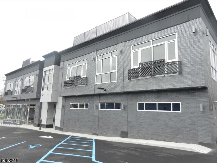 This ideally located modern building is perfectly situated in close proximity to vibrant Downtown Millburn, Mid-Town Direct, Top Ranked  Schools, Shopping, Restaurants & more. A passenger elevator will provide access to the second floor residential apartments. This is an end unit apartment boasting 9' ceilings, spacious living room w/recessed lighting and oversized windows offering street views.  A well appointed contemporary galley kitchen is tastefully finished with quartz countertop breakfast bar, hanging light fixtures, decorative wood cabinetry, stainless steel appliances & enclosed stackable washer/dryer. The primary bedroom is nicely finished with recessed lighting, floor to ceiling windows offering a street view & double wide wardrobe closet.  The second bedroom features a deep wardrobe closet, floor to ceiling window offering a street view and recessed lighting  The rent includes on-site reserved parking for one vehicle.  Tenant responsible for payment of all utilities and first $100 of repairs. This building has a No Pet/No Smoking Policy. SHORT TERM RENTAL WOULD BE CONSIDERED ON A CASE BY CASE BASIS. .