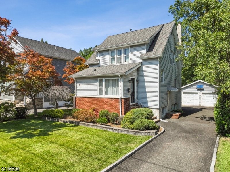 Nestled in a charming neighborhood, this sunlit, move-in ready 3-bedroom, 2-bath Colonial has been thoughtfully updated by its current owners and rests on nearly a quarter acre. The welcoming living area, featuring gleaming hardwood floors, flows effortlessly into the modern eat-in kitchen (renovated in 2018) with granite countertops, stainless steel appliances, and ample cabinet storage. A fully updated bathroom (2020) completes the main floor. Upstairs, you'll find three bedrooms and another full bath, also updated in 2018. Step outside to a beautiful Trex deck with a retractable awning, perfect for enjoying your morning coffee or hosting evening gatherings. The spacious backyard, shaded by mature trees, offers plenty of room for outdoor activities. There you will also find a large detached two-car garage. The unfinished lower level, fully waterproofed with French drains and a sump pump, provides generous storage, laundry space, and a utility room. This lovely home also features central air, multi-zone forced hot air, and a hook-up for a portable generator. Located in a wonderful neighborhood, this home is just minutes from parks, shopping, schools, and NYC transportation. Don't miss the opportunity to make this delightful property yours!