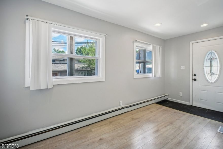 Lower property taxes contribute to more affordable monthly ownership!This charming 4-bedroom, 3 bathroom home (including 2 full baths) has been updated, with new flooring, updated kitchen, and fully renovated basement and bathrooms.The finished basement features a summer kitchen and additional rooms, perfect for extended living, a guest suite, or extra storage. Step outside to a private backyard patio, ideal for relaxing or entertaining. Nestled by Garrett Mountain Reservation, this home is a nature lover's dream while offering easy access to Routes 80, 3, and 46 for effortless commuting. Don't miss this incredible opportunity!