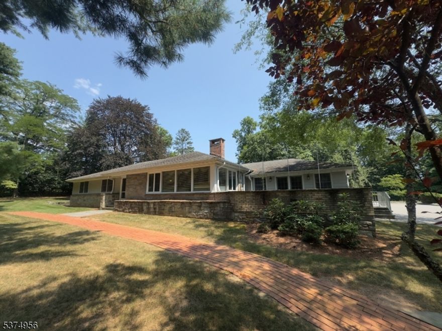 Welcome to your dream retreat in the heart of Madison, NJ. Nestled on 1.5 private acres in one of the town's most coveted locations, this distinctive ranch-style home offers the rare combination of space, style, and convenience all just one mile from Madison's vibrant downtown and direct train service to NYC. Inside, you'll find four spacious bedrooms and two and a half baths, thoughtfully designed for comfortable one-level living. Expansive windows bring the outdoors in, bathing the home in natural light and offering serene views of the lush, park-like grounds. The layout is ideal for everyday living and effortless entertaining, with generously sized living and dining areas, a cozy fireplace, and a seamless connection to outdoor patios and gardens. The home also has a cavernous, unfinished basement with natural light and high ceilings. Whether you're sipping coffee on the patio under mature trees, hosting guests on the lawn, or strolling into town for dinner, this property is a rare opportunity to enjoy the best of suburban living with urban accessibility. A true, very rare Madison gem don't miss it.