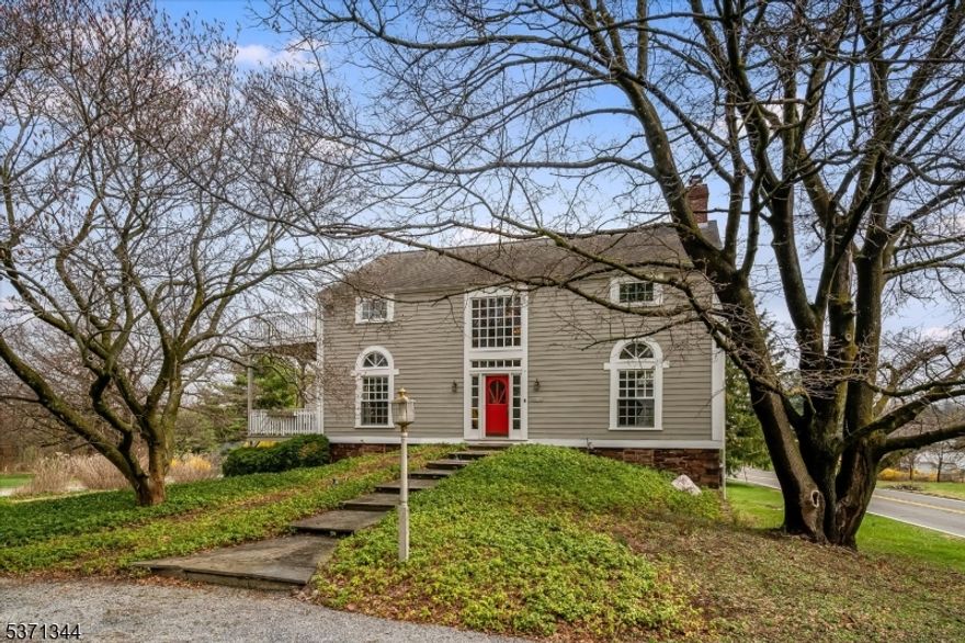 Step into a truly one-of-a-kind home an 1825 converted barn thoughtfully renovated to blend historic charm with modern style. Set on 2 private acres, this 3-bedroom, 2.5 bath residence offers three fully finished levels of living space filled with natural light from dramatic floor-to-ceiling windows. The open floor plan features soaring ceilings, wide plank floors, custom woodwork including architectural staircases and a stunning brick fireplace that anchors the main living area. The home's design is both stylish and functional, creating a cool, contemporary feel while preserving its unique character. Enjoy seamless indoor-outdoor living with multiple decks overlooking mature trees, a beautiful yard and a private walled courtyard perfect for relaxing or entertaining. A separate workshop adds flexibility for hobbies or creative space and the oversized 2-car garage also a converted structure, includes a large loft space above. Every detail reflects craftsmanship and charm, making this home truly special.  A rare opportunity to own a modern, architecturally unique property with timeless appeal unlike anything else on the market!