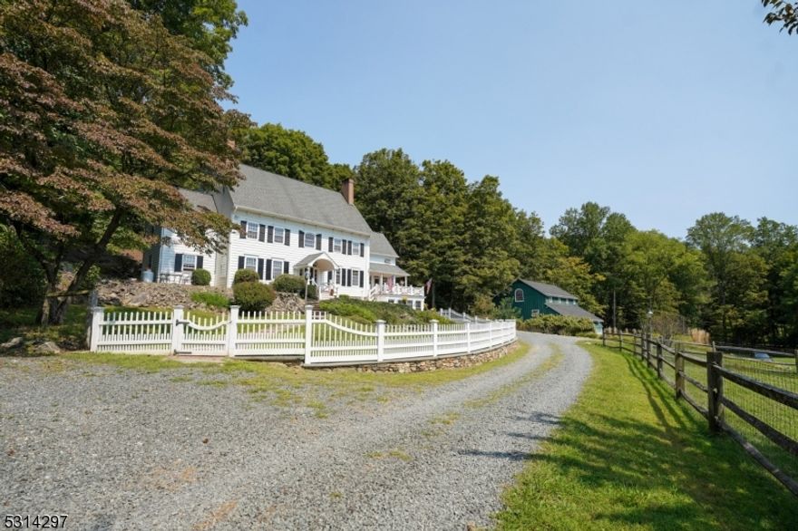 The Hardscrabble Farm is a picturesque colonial estate on nearly 19 acres in Mountainville, Tewksbury Twp, NJ. This farmland-assessed property features a 5-bed, 4.5-bath reproduction home offering charm and modern comforts. The land, divided into two lots, includes a stocked pond, trout-filled brook, and a private island for cozy fires. A stunning mortise-and-tenon barn with a full bath is perfect for gatherings, with horse stalls and storage below. The home boasts spacious rooms, high ceilings, oak floors, 4 fireplaces, a wood-burning stove, and a guest wing with two bedrooms, a living room, and a full bath. The updated pool area, ideal for entertaining, offers a relaxing retreat. Outdoor features include decks, a screened-in porch, and an EV charging station. Too many details to list