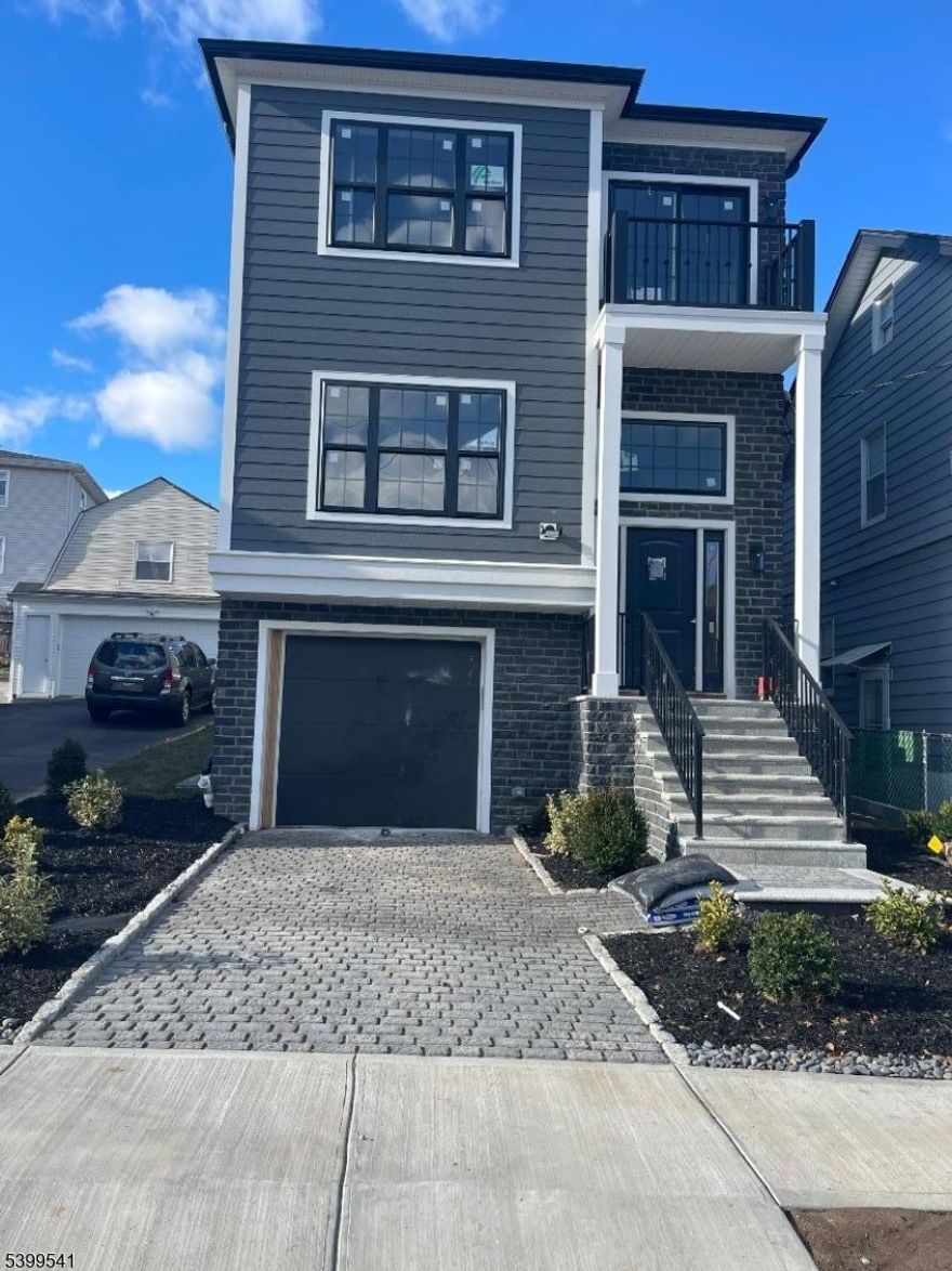 Nearly completed modern comfortable new construction located at 23 Ralph St in Belleville. Conveniently located near to Route 21, 3 and Garden State Parkway. This spacious 4-bedroom 4 full bath home features open concept living room, dining room, elegant kitchen with shaker style cabinets, quartz countertops, stainless steel GE appliances, elegant 72 wide electric fireplace, oak wood floors with mahogany inlay. First floor also features a 19'x12 bonus room' with attached full bathroom, walk in closet, sliding door to Trex deck at rear. Home also features Entertainment room, porcelain tile floor, wet bar, full bathroom Laundry room with front loading washer & dryer, and shelves for storage. High efficiency central heating and cooling for lower level and first floor.  Recessed lighting.  3 parking spaces (2 tandem in garage, 1 on driveway) Poured concrete foundation Second floor includes 3 spacious bedrooms with attached full bathrooms Front bedroom: boasts plenty of windows, balcony with sliding door & 3 spacious closets Other bedrooms: shared common bathroom and plenty of closets Common area: well-designed coffee counter/wet bar with shaker cabinets, quartz countertop, space for wine cooler and microwave Recessed lighting. Gleaming oak wood floor.
