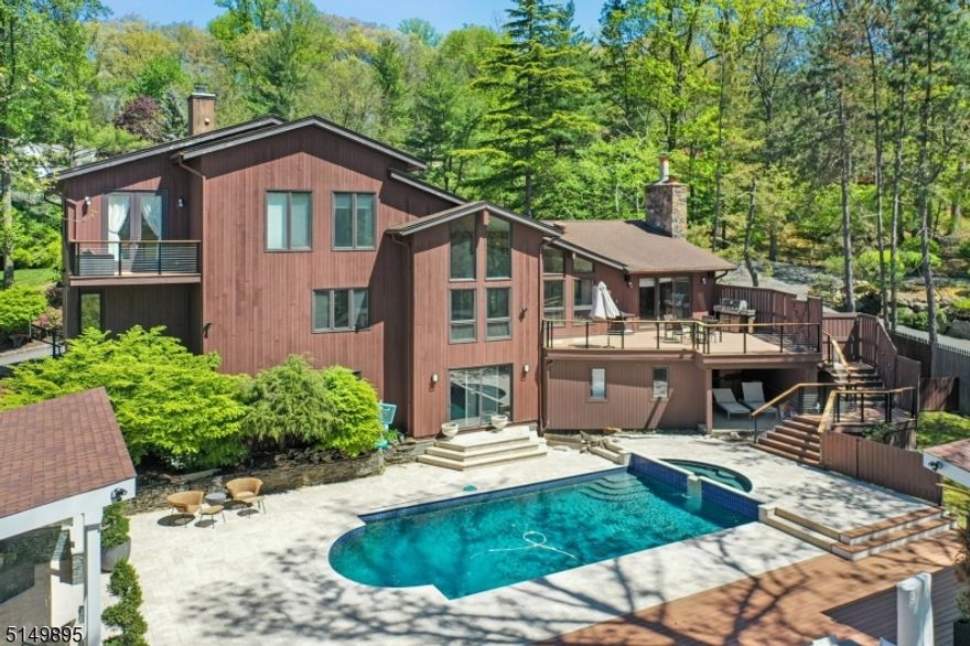 Modern luxury home with magnificent sunset views and resort style outdoor entertainment space! Set in the heart of prestigious Chestnut Hill, this custom contemporary home offers an open airy floor plan as one room flows seamlessly into another. Soaring ceilings and oversized glass windows overlook the pool, private yard and western mountains making it a perfect place to relax and unwind.  A well-appointed Primary Suite boasts oversized windows and sunset views in addition to his and hers bathrooms, walk-in closets and a perfect work from home office. A finished lower level offers an additional family room, bedroom, and bathroom. Renovated in 2021 the fully equipped outdoor kitchen, beautiful outdoor living room, inground pool and cabana create the ultimate entertainment experience.