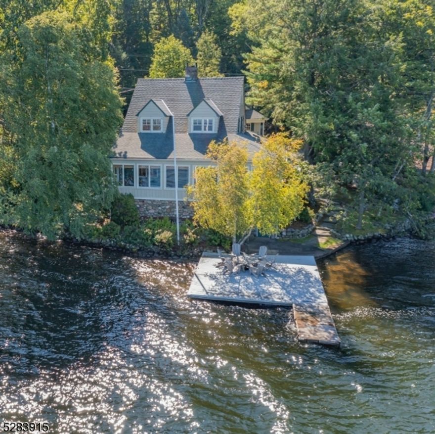 Welcome to "Cabin Point", a lakefront gem located within the desirable Lake End Corporation at Green Pond.  This updated vintage lake house is a true embodiment of charm and character offering a timeless escape with all the modern comforts you desire. Step inside and be greeted by the heart of the home - a custom kitchen with a Sub-Zero refrigerator, Viking  range and custom inset cabinetry, it is a chef's dream, perfect for creating gourmet meals while enjoying lovely views of the lake. As you continue your journey through this enchanting lake home, you'll be drawn to the inviting ambiance of the enclosed 4 season porch with unobstructed views up and down the lake.With a total of 4 bedrooms and 2 1/2 baths including 2 bedrooms and a full connecting bath on the main floor, there is ample space to comfortably accommodate everyone including guests.  Gather around the stone fireplace in the spacious living area where stories are shared and memories are made against the backdrop of tranquil lake views.  Wood floors throughout and French doors add a touch of warmth and authenticity enhancing the rustic charm of the home.Outside, a spacious year round dock beckons for outdoor entertaining and leisurely days at water's edge.  A detached oversized two car garage offers overhead loft with the possibility of being finished. Experience the best of lakefront living, a haven of vintage charm and character. All set against the breathtaking backdrop of Green Pond's pristine waters.
