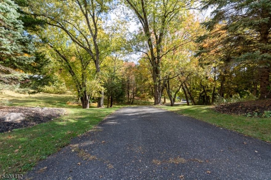 Tucked away on 2 private, park-like acres, this custom one owner home offers the perfect blend of space, style, and serenity located in Clinton with a Lebanon mailing address. Built in 1994 and beautifully renovated in 2020, this 3 bed, 2 full and 2 half bath beauty is filled with thoughtful design and abundant natural light. The stunning living room showcases a wood-burning fireplace and dramatic, oversized windows that flood the home with sunlight and frame peaceful wooded views. An open-concept layout flows seamlessly into the dining area and a gorgeous kitchen featuring plentiful white cabinetry, quartz countertops, stainless steel appliances, a large center island with seating and storage, classic white subway tile backsplash, multiple skylights, and a cheerful breakfast nook. A welcoming entrance foyer sets the tone the moment you arrive. The primary bedroom includes an ensuite bath with stall shower as well as a private deck. While bedrooms two and three are complemented by a full hallway bath. The expansive lower level offers a large family room, storage room, three versatile bonus rooms ideal for home office, gym or den plus a half bath. A long, winding driveway leads through the trees to the barn red home with a two car attached garage. Outdoor living shines with a spacious rear deck and an inground pool your own private retreat. Septic has been inspected and verified for 4 bedrooms. A rare offering that feels like home the moment you arrive.