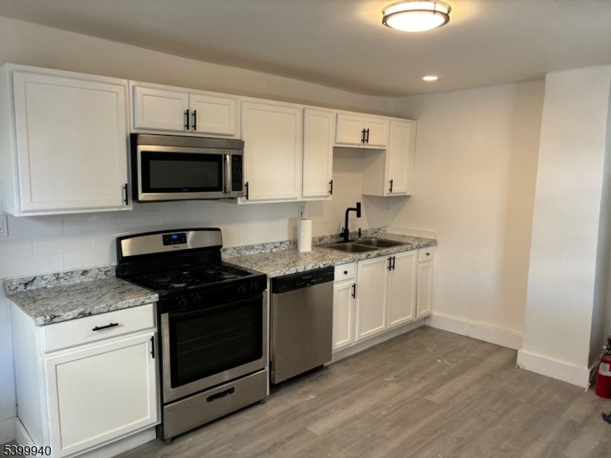 Welcome to this refreshed 3-bedroom, 1-bath home in the heart of Orange, NJ. Step inside to find a bright, modern interior featuring brand-new vinyl plank flooring throughout. This home offers newly refreshed kitchen and an updated bathroom provides clean, stylish finishes with an unfinished basement waiting for you add your personal design. Outside, enjoy the convenience of off-street parking located in the rear of the home. A spacious exclusive backyard offers the perfect setting for relaxing, entertaining, or creating your own outdoor oasis.Move-in ready and thoughtfully refreshed, this charming home delivers comfort, convenience, and modern appeal all in one. Perfect for homeowners or investors alike!