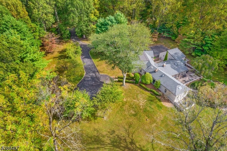 Captivating custom ranch comprising over 3,360 sq ft of commodious living space on on sprawling floor provides the ease & convenience of single level living- this unique home blends striking design, the splendor of abundant natural light, & the beauty of woodland views from a plethora of windows & skylights. Private woodland location on 7.18 picturesque acres (5.73 acres are farm assessed in quaint & beautiful Mendham Twp. 12 rooms including 5 airy bedrooms, 3 full baths, 1 powder room, and 8.5' ceilings throughout; light-filled front entryway; open floor plan living room w 12' vaulted ceiling; comfortable family room features a handsome raised-hearth fireplace flanked by built-ins; attractive designer kitchen boasts abundant wood cabinetry, gleaming granite countertops, and premium stainless steel & panel appliances; resplendent breakfast room; tasteful dining room has courtyard views; superb cloistered primary bedroom suite is located far from the other 4 bedrooms; well-appointed laundry room; inviting paver patio; attached 2-car garage with paved driveway & ample parking; the long-term peace-of-mind of a brand new 5-bedroom septic to be installed prior to closing.  This property is just beautiful complimented by a Sylvan sparkling free-form, in-ground, swimming pool with spa & updated pool equipment, including a new heater.  Mendham offers Blue Ribbon elementary & middle schools plus top-ranked Mendham High School with its advanced placement (IB) program.