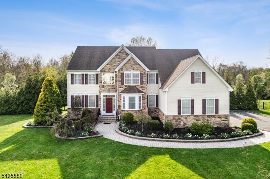 Built in 2012 and just moments from town, this exceptional Northeast facing estate is set on 2 fenced acres at the end of a cul-de-sac, among other fine homes. A grand 2-story foyer with wrought iron balusters & oak treads welcomes you into an open layout with hardwood floors & elegant formal living & dining rooms. The soaring family room features a vaulted ceiling, rear staircase & wood-burning fireplace. The adjacent eat-in kitchen is a standout with a center island, double wall oven, gas cooktop with hood & breakfast area overlooking a resort-style backyard. A private study with french doors, mudroom & updated powder room complete the main level. Upstairs, enjoy 4 spacious bedrooms & 3 full baths, including a princess suite, Jack & Jill bath & a luxurious primary suite with double-door entry, sitting room, sauna, 2 oversized walk-in closets, tray ceiling & spa-like bath with jetted tub & dual vanity. Tile flooring throughout the bedrooms offers a clean, modern aesthetic. Step outside to your private retreat featuring a heated in-ground pool (2025 heater & pump), spa, expansive paver patio with pergola & firepit, vegetable garden & gorgeous sunset views. Additional highlights include public sewer, OWNED solar panels, whole-house generator, 2-zone heat/AC, full basement, 3 car garage, lawn irrigation, shed & driveway pickleball court. All appliances remain. Ideally located near Neshanic Valley Golf Course, kayaking, hiking, Bridgewater, Princeton, NYC train & major highways.