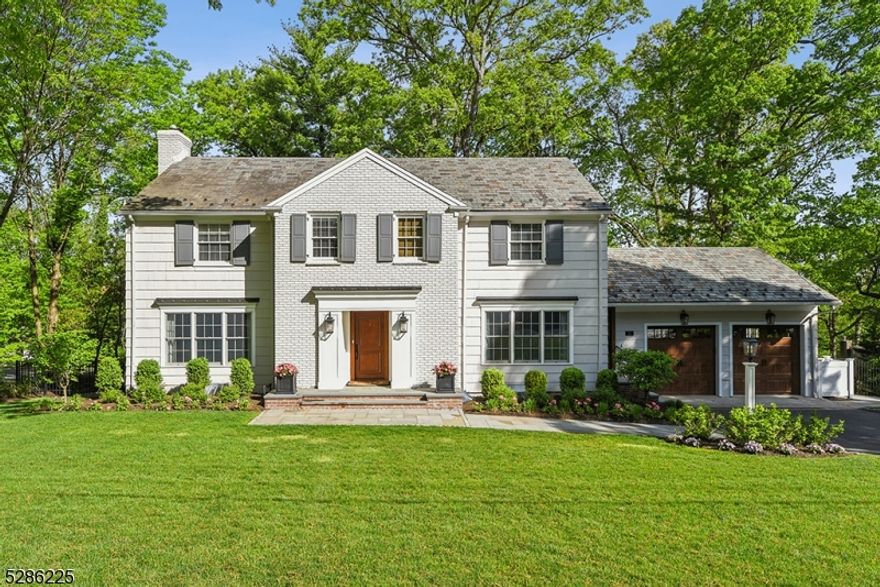 Gracious totally updated Center Hall Colonial in one of Summit's most desirable locations. Formal Living room with fireplace, has French doors to adjacent Family room. A stunning gut renovated designer kitchen features soft gray and white cabinetry, quartz countertops and top of the line KitchenAid appliances. A butler's pantry/service bar connects the kitchen to formal Dining room. A spacious separate dining area adjoins the kitchen with double doors which open to an elevated Timbertech deck with stairs leading down to a bluestone patio that spans the entire length of the house. The patio features a gas fire pit, a covered area with outdoor TV and a pass through service bar perfect for outdoor living. The Primary suite has an updated bath and custom walk in closet. Three additional bedrooms and an updated hall bath complete the second floor. The Lower level which opens to the rear patio features a Game Room and a well appointed Rec Room with a gas fireplace and a custom wet bar with counter seating, an under mount refrigerator and built in Kegerator for great entertaining. A sun filled fifth bedroom and nearby updated hall bath are perfect guest quarters or a home office.  A large new laundry room and storage areas complete this level.