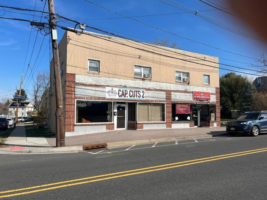 Excellent mixed-use investment opportunity in downtown Manville just off N. Main St., across from Wal-Mac. This corner property features 5 income-producing units: 2 fully rented street-level commercial stores and 3 leased residential apartments (1BR/1BA, 2BR/1BA, 3BR/1BA) plus 2 garages generating additional income. Strong tenant base with immediate cash flow and potential for future rent increases. Great opportunity for investors seeking stable income in a high-visibility location.