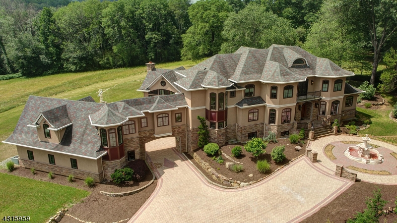 This Fabulous Custom Home is one of a kind overlooking the 6.79 acre lot with a private pond, and just minutes from the Denville NJ Transit Train Station. Features such as Brazilian Cherry floors throughout the 6 bedrooms and 7 bath luxury home, Dramatic Great Room and Breakfast Area with Stone Wall fireplace Dining Room with French doors leading to the patio. 1st Floor. Master Suite with F/P Full Master Bath with  Sauna, Dual WIC, dressing room and private sitting area, Gourmet Custom Kitchen offers Sub-Zero fridge and freezer, copper farm sink, gleaming granite center island, full W/I pantry. in-law suite has private entrance, 1 BR, 1 BTH and LR. 3 Story Spiral Stair leads to 2nd floor then to loft, finished Basement to enjoy a Game Room with F/P., Media Room, Steam Bath, 6 Car Garage for car enthusiast
