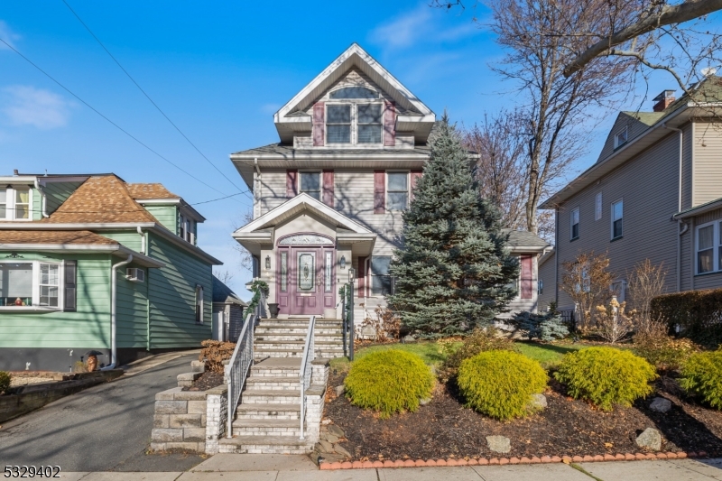 Meticulously maintained and tastefully updated, this classic side-hall colonial sits in a centrally located neighborhood. The first floor begins with a welcoming mudroom entrance that leads to a spacious Living Room, formal Dining Room, and a custom Kitchen with island and top-of-the-line appliances. A versatile den/guest suite offers seamless access to the large rear deck and overlooks the perfect yard. The second floor offers a Primary Bedroom with ensuite bath, walk-in closet, and a stunning built-in wall unit, along with two additional Bedrooms and a Full Bath. The third floor includes two bright Bedrooms and a half bath. A full basement with laundry room and storage. Step outside to the large, deep, and beautifully designed outdoor space featuring professional turf with no maintenance required. Fenced in yard, deck, sprinklers, alarm systems and detached 1 car garage. Perfectly situated within blocks of schools, parks, shopping, and transportation.