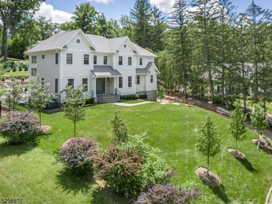 FAB NEWLY BUILT HOME WITH EVERY BELL AND WHISTLE! A true "Masterpiece  of design from renowned local architect Steve Hockstein, this 7 Bedroom, 6.1 Bath home in desirable Deerfield section of Short Hills, offers 7,113 sq ft with astounding amenities, such as custom white oak floors, imported Italian tile, amazing light, and glorious high ceilings. 2-story grand Entry Foyer sweeps you through formal Living Room and elegant Dining Room. Sun-drenched Family Room with coffered ceiling and chic fireplace opens to glamorous Chef's Kitchen, creating the ideal space for easy living, with Quartz countertops, crisp white cabinetry, Carrara marble backsplash, Thermador SS appliances (3 refrigerators, 2 dishwashers, 6-burner gas stovetop/griddle, double oven) and tremendous triple glass door sliders that lead to enchanting private Backyard with bluestone patio, in-ground pool, natural stone retaining walls, and grassy area, perfect for play, pets, and fun gatherings. Plush Powder Room, En-Suite Bedroom, and Home Office/Bedroom completes 1st Level. 2nd Level boasts 3 spacious En-Suite Bedrooms with lavish Bathrooms. Luxurious, bright Primary Bedroom stuns with vaulted ceiling, Home Office (with "Secret Room! ) and 2 massive WIC's, plus spa-like En-Suite Bath with free-standing tub, glass door shower, and toilet closet. Take the ELEVATOR to Lower Level and find Recreation Room, Exercise Room, 7th En-Suite Bedroom, custom-cubbied Mud Room, huge 3-car garage, and tons of storage.