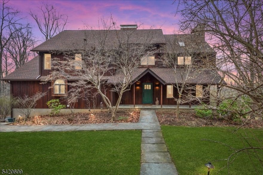 Exceptional Custom Home on a private & wooded 5 acre lot by 147 acre Teetertown Ravine Nature Preserve. Loaded w character this home is filled w upgrades including hardwood floors on both levels & walls of oversized windows to take advantage of the tranquil setting & winter valley views. Designed for entertaining w a resort-style in-ground pool, paver patios & expansive mahogany deck. Cathedral ceiling living room w Vermont slate flooring & French door to deck is centered on a stunning floor to ceiling exposed brick fireplace. Spacious family room w wood-burning fireplace. Gourmet kitchen w  center island, granite counters, tile backsplash & new stainless steel refrigerator. Breakfast room w vaulted ceiling, bank of custom cabinetry, breakfast bar & stacked windows flows to the sunroom w sliders to the deck. A curved staircase leads to the upstairs hallway landing overlooking the living room featuring a loft area w custom built-in bookcases. Primary bedroom suite has 2 closets including a walk-in closet & lavish bath w stall shower, jetted tub, skylight & slate tile. Generously sized secondary bedrooms have great closets. Updated main bath w tub shower & decorative tile. The wood paneled finished daylight walkout basement w rec room, office & full bath makes a great option for an in-law suite. Desirable location near historic Califon is close to shopping, dining & numerous parks. Great commute near Rts 78,31,22 & bus/train service. Prestigious Blue Ribbon Voorhees High School