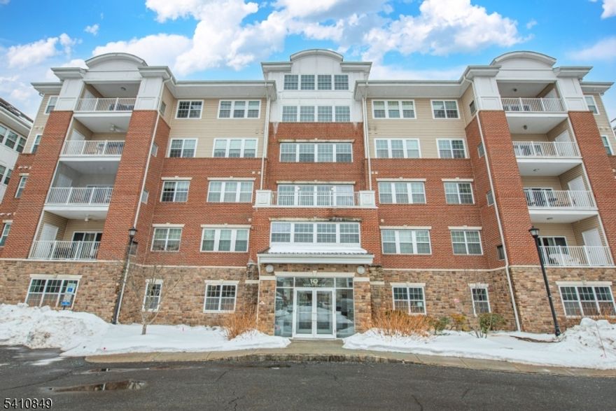 Opportunity knocks on Warren's Way in the sought-after 55+ community of Wanaque Reserve. This Colfax Model in Building 10 offers comfortable one-floor living and a private unit tucked into its own quiet nook overlooking the quiet woods and the unit is conveniently located right by the elevator (no hauling groceries across the building - future you says thank you).The kitchen is spacious and functional with plenty of cabinetry, pantry storage, and an adjacent laundry room   ready for your personal updates and design vision. The primary bedroom suite features a walk-in closet plus an additional closet for excellent storage, along with a full bath offering a double vanity, walk-in shower, and private toilet area. A second bedroom and full hallway bath provide flexible space for guests, hobbies, or home office use. This unit comes with it's own separate storage unit on the same floor and two assigned parking spots in the garage. And then there's the lifestyle because Wanaque Reserve is basically a resort with mail delivery. Enjoy a state-of-the-art clubhouse with cafe serving breakfast and lunch, indoor and outdoor pools ballroom with Broadway-style entertainment, sidewalks, tennis, bocce, pickleball, and over 40 clubs and activities including travel groups, social clubs, and more. Perfect for buyers looking to downsize, customize, and still live large.