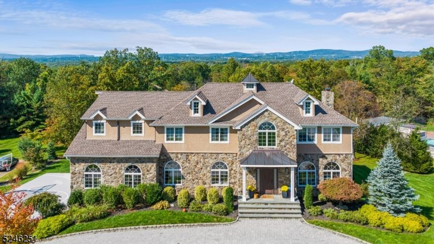 Welcome to luxury living at its finest! This sprawling custom colonial offers an array of amenities that will delight even the most discerning buyer. From the moment you arrive, you'll be captivated by the paver driveway leading to this magnificent residence. Outdoor entertainment is a breeze w/ a sports court, fire-pit & Trex deck overlooking the stunning in-ground heated two-tier pool featuring a water slide, hot tub & waterfall. The covered outdoor bar provides the perfect setting for hosting gatherings, complete w/ ample seating for guests to enjoy. Inside, the grandeur continues w/ a 2 story foyer, hardwood floors & elegant arched doorways & windows. Cozy up by the gas fireplace in the den or entertain in the spacious formal living & dining room. The eat-in gourmet kitchen is a chef's dream w/ high-end appliances, large center island & 2 built-in desks. Retreat to the 1st fl bedroom w/ a full bath. The 2nd level boasts 5 bedrooms, including a master suite w/ 2 walk-in closets & a luxurious bath featuring a jetted tub, stall shower & dual vanities. Additional highlights include 2 more full baths & a laundry room on the 2nd level. The lower level full finished walk-out offers even more space for relaxation & entertainment. Sitting room, music room & another full bath complete the lower level. Don't miss your opportunity to call this extraordinary property home!