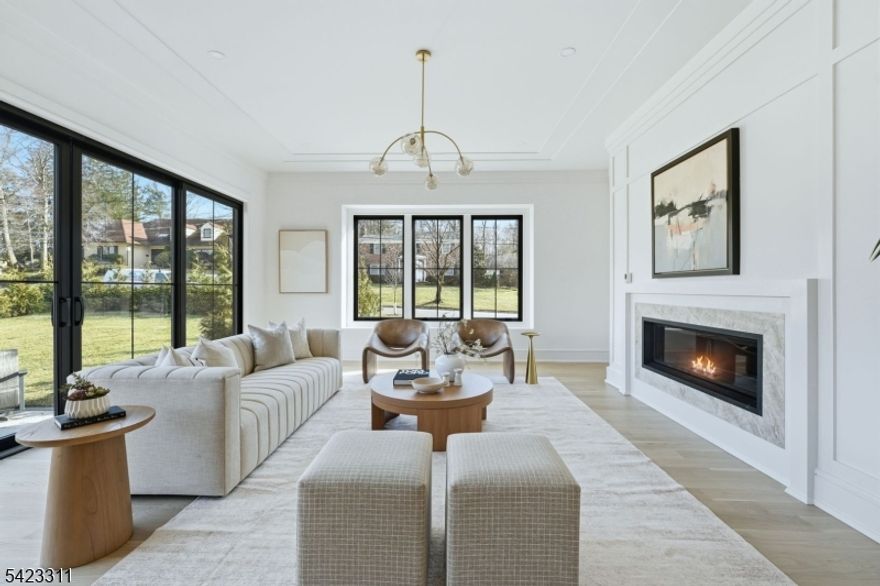 Welcome to a truly exceptional NEW CONSTRUCTION CUSTOM home, thoughtfully designed by award-winning architect Thomas Baio and acclaimed interior designer Karen Wolf of K+Co Living. Nestled in the highly sought-after Deerfield Section of Short Hills, this 7-bedroom, 7.1-bath residence offers architectural sophistication with everyday comfort. The grand foyer welcomes you, setting the tone with elegance and scale. The formal dining room captivates w/ a custom feature wall and designer lighting, creating an unforgettable backdrop for entertaining. The flow continues into the open-concept family room, where a linear gas fireplace serves as a striking focal point and natural gathering place. Just off the family room, a wall of glass doors open to a patio and level yard, w/space for a future pool. The designer kitchen impresses with Wolf/Sub-Zero appliances, dual DW, quartz countertops, and a cozy breakfast nook perfect for casual dining and everyday moments. A private guest suite and a dedicated home office with covered porch complete the first floor. Upstairs, the primary suite offers the ultimate in comfort and style, boasting dual custom walk-in closets and a spa-inspired bath with a soaking tub, His & Hers sinks, and oversized shower with dual controls. Four additional bedrooms, each w/full bath and walk-in closet. The finished basement provides entertaining & playspace, and mudroom access direct from the oversized three-car garage adds everyday convenience.