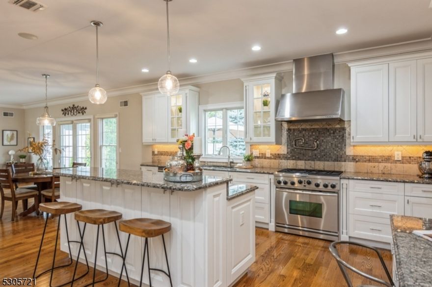 Come indulge in the pinnacle of luxury with this exquisite, light-filled 4-bedroom colonial, the epitome of refined living. The gourmet kitchen is a masterpiece, adorned with granite surfaces and high-end stainless steel appliances, centered around a magnificent island. A sophisticated butler's pantry adds a touch of elegance and convenience. The family room, featuring a stately fireplace, seamlessly opens to a serene backyard patio through exquisite atrium doors, creating an ideal space for both relaxation and elegant gatherings.  The Hardie-Plank and stone exterior presents timeless elegance, while oak floors with walnut accents imbue the first and second levels with opulent charm. The primary suite is a private sanctuary, offering an oversized walk-in closet and a double-sided fireplace that graces both the bedroom and the sumptuous en suite bathroom. This residence is completed with a two-car garage featuring a state-of-the-art charging system, a paver stone driveway, and an underground sprinkler system to ensure immaculate landscaping. Nestled in a quiet neighborhood, this home epitomizes luxury and sophistication at its finest.  Approx. 5,100 square feet including the third floor which is complete with a full bath for a guest suite or a dedicated home office and a fully finished, open basement with a rec room, bonus room, bathroom and extensive storage!!