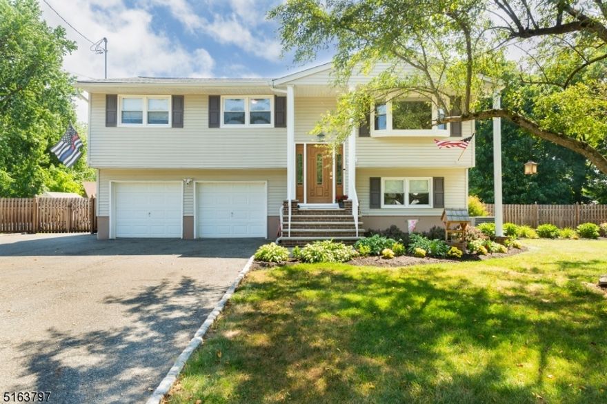 Welcome to your home and staycation!  Pride of ownership is exhibited everywhere in this beautifully maintained and updated home on a simply magnificent piece of property, C/A upper l bel, Lowe level split system is air! .    Be ready to be WOW'D as you enter through the custom wood front door with decorative glass side panels in the foyer.  Newly painted throughout!  Hardwood flooring throughout the Front Foyer, Hallway, Dining Room, Living Room and bedrooms. UPDATES GALORE!  Wood-like laminate flooring in this beautifully updated kitchen with stainless steal appliances.  The open floor plan with seamless room transitions leaves this home with endless entertainment possibilities.  Three Season Sun Room with wood-like laminate flooring creates the perfect atmosphere for year round living, relaxing and entertaining.  The enormous Recreation Room located on the ground level offers a wide range of possibilities.  Office, Utility Room, Laundry Room all located on the ground floor.  This home features a heated garage, 15KW Generator and an on-demand water heater located in the garage.  Make sure you save the best for last as you step outside through the sliding glass doors off the kitchen to our oasis of a backyard.  In-Ground Pool with a 2 year old pool liner and salt water pool system, a backyard as far as the eye can see, paver patio porch underneath the deck and a hot tub to make this staycation nothing short of perfection!  Don't miss this beauty because it won't last long!