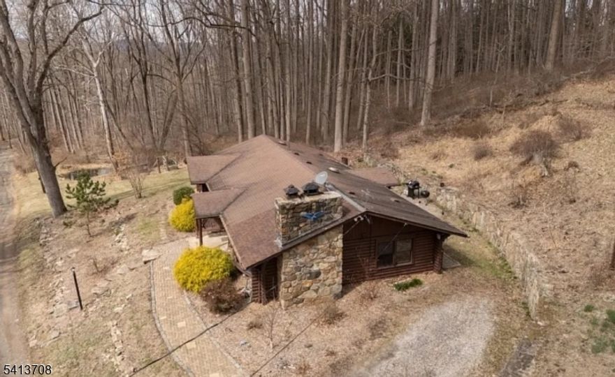 Situated on a serene 6.9-acre wooded lot, rustic log ranch home with large bay window of the stunning natural surroundings creates a warm and welcoming atmosphere throughout the home. Step outside to enjoy the landscaped yard, complete with a private paver patio ideal for entertaining or unwinding in solitude. Inside, the open floor plan provides for a roomy kitchen, great room and dining room along with three bedrooms and bath featuring a separate tub and shower. Partially finished basement, with a workshop area, and abundant storage space for all your needs. Wood burning fireplace and wood burning stove provide extra warmth on chilly days. Enjoy the perfect balance of privacy and convenience, with easy access to shopping and highways. This lovely log home offers great year-round living or serves as a perfect weekend retreat. Don't miss the opportunity to make it yours!