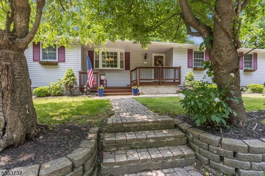 Move right in to this beautifully renovated one floor living custom ranch home!  The owners customized this home in 1997 adding vaulted ceilings in the Living/Dining rooms and Kitchen. One floor living at its best.  This 3 bedroom 2 full bath home with a bonus Den and 3 Season Room has so many updates including the following:  Roof 2022, Furnace 2023, Water Heater 2024,  main & Primary bath redone in 2020.  The home is designed with an open concept/easy flow between the Kitchen, Living rm, Dining rm, 3 Season Rm and den.  Great for entertaining guests or just relaxing under the high ceilings.  The 3 Season Rm is a plant lovers paradise & nice retreat, with new vinyl flooring 2023 & walls of glass and sliders to the back yard.  The Laundry Room is off the kitchen with a pantry & access to the 1 car garage.  A full basement for storage  and a craft/project room too. Do not worry if there is a power outage.  There is a generator hookup and the owner is leaving their portable generator behind.  Step outside to this nature lovers dream.  There is a front porch 2 back decks & a patio.   The gardens are beautiful and the home is surrounded with beautiful plantings, a wooded back area, & large natural rocks that hug the back deck area.  Thee are two storage sheds.  There is parking for 10+ so invite everyone! backs to hundreds of Green Acres & more across the street