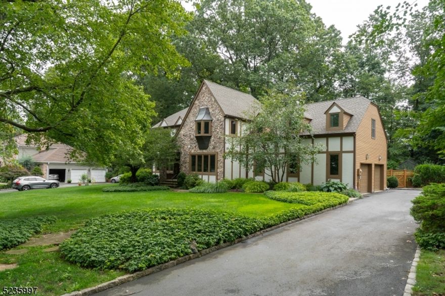 Welcome to this Beautiful Colonial Tudor property situated on a professionally landscaped half acre in desirable Summit section of Basking Ridge.  Exceptional floor plan - two story Family Room with stone 'floor to vaulted ceiling' fireplace/skylights; first floor office/den, formal Dining Room, Eat in Kitchen with access to tiered deck, laundry and powder room.  Entire home hardwood flooring (stairs and upper hall included). Second level features Master Bedroom with walk in closet plus, luxurious jacuzzi master bath; four additional  bedrooms.  Lower level offers three additional areas of finished living space.  Enjoy the pristine, private and serene rear of property from your deck with beautiful landscape design and side wood decorative fencing. Whole house Generator.  Fireplace, central vacuum, speakers in Kit and FR 'as is' - no known issues.   A wonderful community and lifestyle not to be missed!  Convenient to transit, highways, shopping and  restaurants.