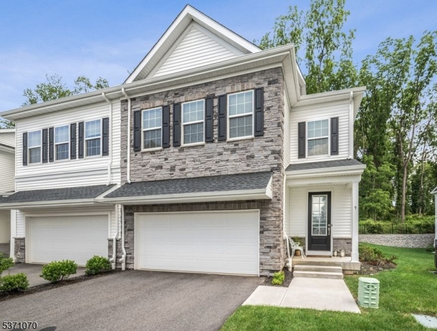 Welcome to your dream home at The Collection at Morris Plains a stunning, like-new End-Unit Townhome offering beautifully finished living space. Situated on a private wooded homesite, this upgraded Monterey model combines luxury, comfort, and convenience. Step inside and fall in love with the open-concept featuring 9-foot ceilings, rich wood floors, and a designer gourmet kitchen complete with a huge quartz center island, 42  shaker-style cabinetry, SS appliances, and pantry. The spacious dining area flows effortlessly into the bright living room with sliding glass doors that open to a serene outdoor space, perfect for entertaining or relaxing. Upstairs, 9-foot ceilings continue, elevating the spacious feel. The luxurious primary suite features 2 WIC and a spa-like en-suite bath with granite counters and  ceramic tile floors. 2 additional bedrooms, an upgraded bath, and a convenient laundry room complete the floor. The finished lower level offers even more flexible living space with a full bath, ideal for a rec-room, home office, or exercise area.  The oversized two-car garage impresses with epoxy floors, finished walls, and dramatic ceiling lighting. Enjoy easy access to the Morris Plains NJ Transit direct train to NYC, I-287, I-80 & Route 10, plus all the shops, restaurants, and entertainment of nearby vibrant Morristown. Outdoor enthusiasts will love the proximity to parks, golf, trails, and more. Don't miss this rare opportunity with premium upgrades already in place!