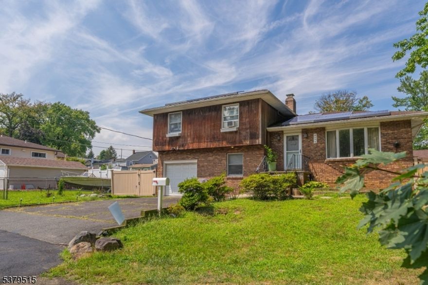 Spacious 3BR/2Bath. Well-maintained bi-level home on a desirable corner lot at the end of a quiet dead-end street, bordered by woods and natural vegetation for added privacy. The main level offers a bright living room, dining room, and updated kitchen, all with hardwood floors. Upstairs, you'll find 3 bedrooms and a full bath. The lower level includes a second full bath, a summer kitchen, extra rooms for flexible use, and a large family room with a chimney and French doors leading to the backyard. Another set of French doors opens from the deck, creating great indoor-outdoor flow. The tiered, park-like yard is ideal for gardening, entertaining, or simply relaxing.House is being sold "AS IS".