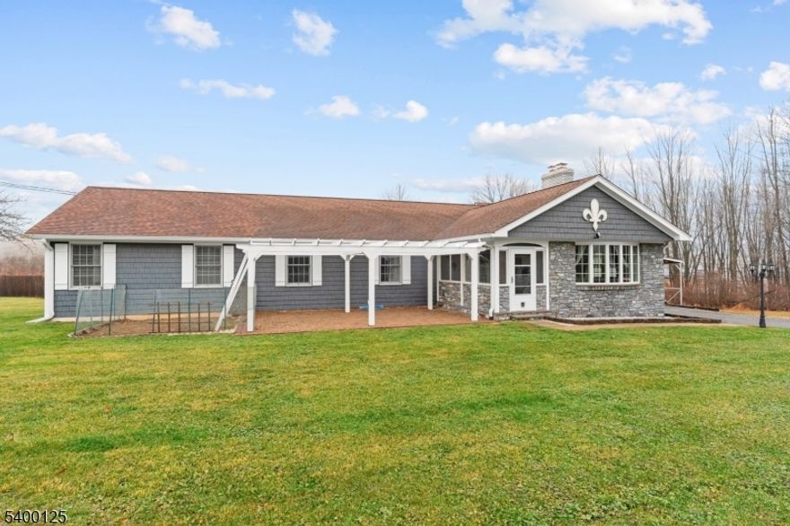 Welcome to Mount Olive Township! This beautifully renovated expanded ranch at 18 Old Wolfe Rd, Budd Lake offers approximately 2,960 sq ft of living space with 5 bedrooms and 3 full bathrooms on a spacious 0.69-acre lot. The home features a gourmet kitchen with quartz countertops, custom cabinetry, farmhouse sink, and center island, along with hardwood floors, recessed lighting, and Andersen windows throughout. The primary suite includes a walk-in closet and a luxurious bath with jetted tub and heated floors. A finished walk-out basement with a separate entrance offers versatile living space and added functionality. The property also features an oversized garage with high ceilings and a staircase leading to loft storage, providing excellent space for storage, workshop use, or larger vehicles. Conveniently located in the Budd Lake section of Mount Olive Township with easy access to major highways, shopping, and local amenities.