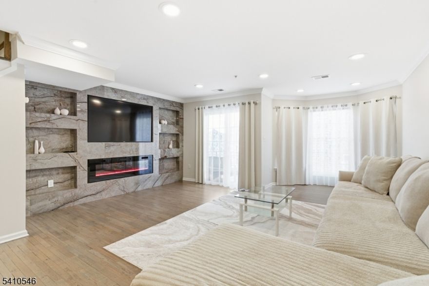 Welcome to this well-maintained 2-bedroom, 3-bathroom condo located at 107 Adamecs Way in South Amboy. This unit offers a bright and open living area featuring recessed lighting, hardwood flooring, and a modern electric fireplace with built-in shelving, creating a comfortable and functional space. Large windows and sliding glass doors provide abundant natural light and access to outdoor space. The layout includes generously sized bedrooms and three full bathrooms, offering flexibility and convenience. Located within a professionally managed community with close proximity to shopping, dining, major roadways, and public transportation. Come turn this house into your home before someone else does!