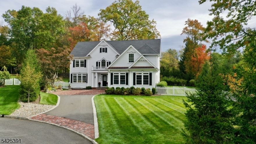 Welcome to this stunning newer-construction home built in 2019, gracefully set on a quiet Madison cul-de-sac. Thoughtfully designed with custom moldings and updated finishes throughout, the home blends timeless elegance with modern comfort. The main level offers gracious living and dining rooms, a private office ideal for working from home, and a beautifully appointed kitchen featuring top-end appliances and a large center island. The kitchen flows seamlessly into the relaxing family room, where a natural gas fireplace creates a warm and inviting gathering space. A functional mudroom adds everyday convenience. Upstairs, the expansive primary suite is a true retreat, highlighted by a natural gas fireplace, generous walk-in closet, and a spa-like bath designed for relaxation. One bedroom serves as a junior suite with its own private bath, while two additional bedrooms share a Jack-and-Jill bath and extra large sitting / dressing room and closet. A conveniently located laundry room completes the second floor. The finished basement offers flexible recreation / living space with a kitchenette and full bath, while a walk-up attic provides excellent storage or future expansion potential. Curb appeal is enhanced by a paver-accented driveway apron and landing leading to the oversized two-car garage. With refined finishes, a versatile layout, and a prime Madison location, this exceptional home delivers a truly elevated lifestyle.