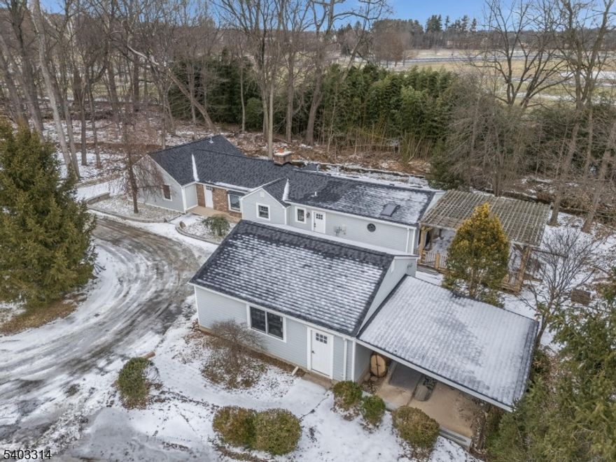 Tucked away and completely renovated in 2025, this charming single-family ranch offers the perfect blend of modern comfort, natural beauty, and everyday convenience. Privately set back from the road, the home feels like a peaceful retreat where the gentle sound of a babbling stream alongside the property creates a calming backdrop. Inside, the home welcomes you with warm, light-filled spaces and thoughtful details throughout. The spacious family room features a soaring cathedral ceiling and French doors that lead to a large deck with pergola and adjoining patio, an ideal setting for morning coffee, relaxed gatherings, or quiet evenings outdoors. The living room is full of character with its cozy beamed ceiling and wood-burning fireplace, adding texture and timeless charm. The completely renovated kitchen is both beautiful and functional, featuring a striking stone wall, stainless steel appliances, brand-new cabinetry and countertops with abundant storage which invite everyday cooking and entertaining alike. With three comfortable bedrooms and two full bathrooms, the primary bedroom stands out as a serene retreat with generous space and an impressively large closet. Lenape Park, just across the stream, feels like an extension of your own outdoor space and you are just minutes from shops, dining, and local amenities. Warm, welcoming, and wonderfully private, yet close to everything, this home offers a rare sense of comfort, ease, and belonging.