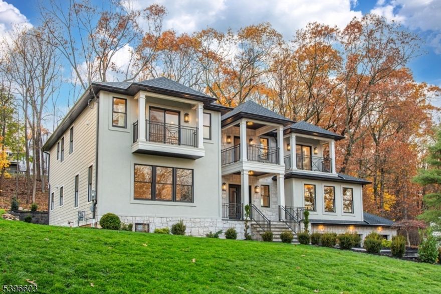 Experience elevated living at 24 Cliffside Drive, Livingston, an exquisite new construction estate spanning approximately 6,500 sq ft of refined design and craftsmanship.This 5-bedroom, 6.5-bath luxury home combines timeless architecture with modern sophistication, offering the ideal blend of comfort, function, and style. Step inside to a grand foyer that opens into bright, open-concept living spaces adorned with custom millwork and oversized windows. The chef's kitchen is the centerpiece of the home, featuring a striking double-profile quartz island, matching full-height quartz backsplash, professional-grade appliances, and a butler's pantry for effortless entertaining. The adjoining kitchen and living room are anchored by a sleek fireplace, while a second fireplace enhances the formal dining room's elegant ambiance. Upstairs, retreat to the primary suite with a spa-like bathroom, custom walk-in closet, and a private balcony overlooking the grounds. Two additional balconies provide peaceful second-floor escapes. The fully finished basement expands the living space with a wet bar, wine cellar, media area, and recreation space, perfect for gatherings or relaxation. Outdoors, enjoy a covered patio with a outdoor kitchen, ideal for year-round entertaining. The stone and stucco exterior, three-car garage, and 10-year builder's warranty complete this extraordinary offering. 24 Cliffside Drive redefines modern living in one of Livingston's most sought-after neighborhoods!