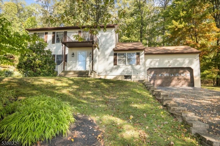 OPPORTUNITY KNOCKS!! Discover this rare chance, in the heart of Rockaway, to own a custom-built true mother-daughter home, lovingly owned and immaculately-maintained by the same family since 1981. Tucked away on a peaceful wooded lot yet just minutes from highways, shopping, and schools, this home offers the perfect balance of tranquility, convenience, and opportunity. The main level features three comfortable bedrooms, including a primary suite with its own half bath, a full bath, a spacious living room, a classic kitchen, and a dining area that opens to a large screened-in porch which is an ideal spot to relax or entertain. Upstairs, the dedicated mother-daughter suite provides a private living space with one bedroom, a full bath, a large eat-in kitchen, a living room, and an additional office or hobby room. This well-cared-for home boasts original hardwood floors throughout, a Generac gas generator, central air, public utilities, and a brand-new water heater. An oversized two-car garage and a huge walkout basement with a separate entrance add both value and flexibility, with the basement offering endless potential to finish and expand. True mother-daughter homes like this are rarely available in Rockaway, making this property an exceptional opportunity for buyers looking to create a welcoming space for versatile living.