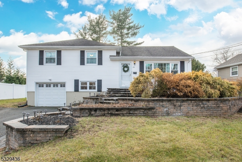 This exceptional home is located on a quiet street, with impressive curb appeal, new windows, siding, and recent renovations. With three finished levels, it offers a spacious layout ideal for entertaining, plus inviting outdoor spaces. Inside, the bright formal living room flows into a stunning kitchen with quartz countertops and stainless steel appliances. The family room features large windows and a wood-burning fireplace. The second floor has three bedrooms and a full bath. The ground floor includes a half bath, backyard access, garage entry, and a versatile den/office space. The finished basement has a new laundry area. Outside, the tiered deck overlooks a flat backyard ideal for gatherings. This home truly has it all!