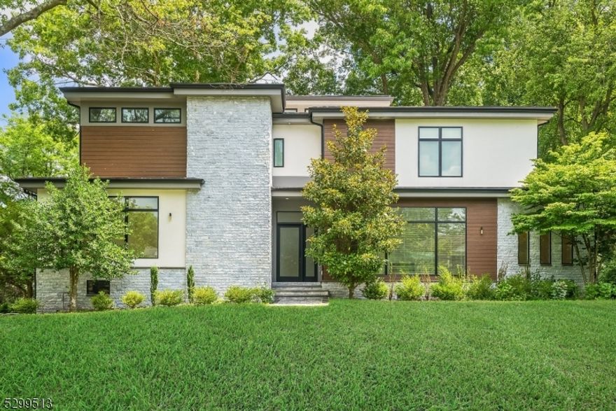 An architectural contemporary showpiece of grand living space & an open floor plan featuring 5 beds, 4.5 bths, soaring ceilings, gleaming 6" wide plank, white oak flrs, glass railing staircase throughout, recessed lighting, automated lighting systems, exceptional gourmet kitchen featuring spacious center island, dark gray cabinetry w/ under cabinet LED lights, dark walnut accents, frosted subway tile backsplash, sleek quartz countertops, Subzero refrigerator, Wolf double wall oven & gas cooktop, built in microwave, Bosch dishwasher, complete with a window lined eat in area & access to the deck. Family room is illuminated by walls of grand windows, w/ double sided fireplace open to the dining room leading you to the living room. The primary bedroom is expansive w/ private spa like bath, neutral stone flooring, stone tiled statement wall, soaking tub, grand glass enclosed shower, dual sink floating vanity & spacious fully outfitted WIC w/ built in drawers. Two additional bedrooms share a jack & jill bthrm complete w/ dual sink vanity & glass enclosed shower area. The spacious loft w/ terrace & laundry room complete the top floor. Just a short level up from the first floor rests a pwdr room, office & additional bedroom w/ en-suite bath making the perfect in-law suite. The ground floor and basement are finished with loads of space, additional bedroom and rec room with full bath. Top rated Millburn schools, Mid Town Direct Train line, close to shops & restaurants.