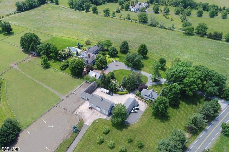 Deerfield Farm Estate and Equestrian facility sits atop 34.44 acres and enjoys breathtaking unobstructed views of the Somerset Hills to the south and west. Renovated in 2014, the main house boasts 6 bedrooms (5 ensuite), 6.3 baths & 11 fireplaces. Equestrian complex includes a riding ring, 8 stalls, tack room w/ wash stalls, barn & 4 garages. 3 Bed cottage & detached 3 car garage with second floor. 2 bedroom office complete the out buildings.  Grandeur at its finest, 4 sets of doors exit to a sweeping bluestone patio, gardens, sunset patio, & sensational pool area.