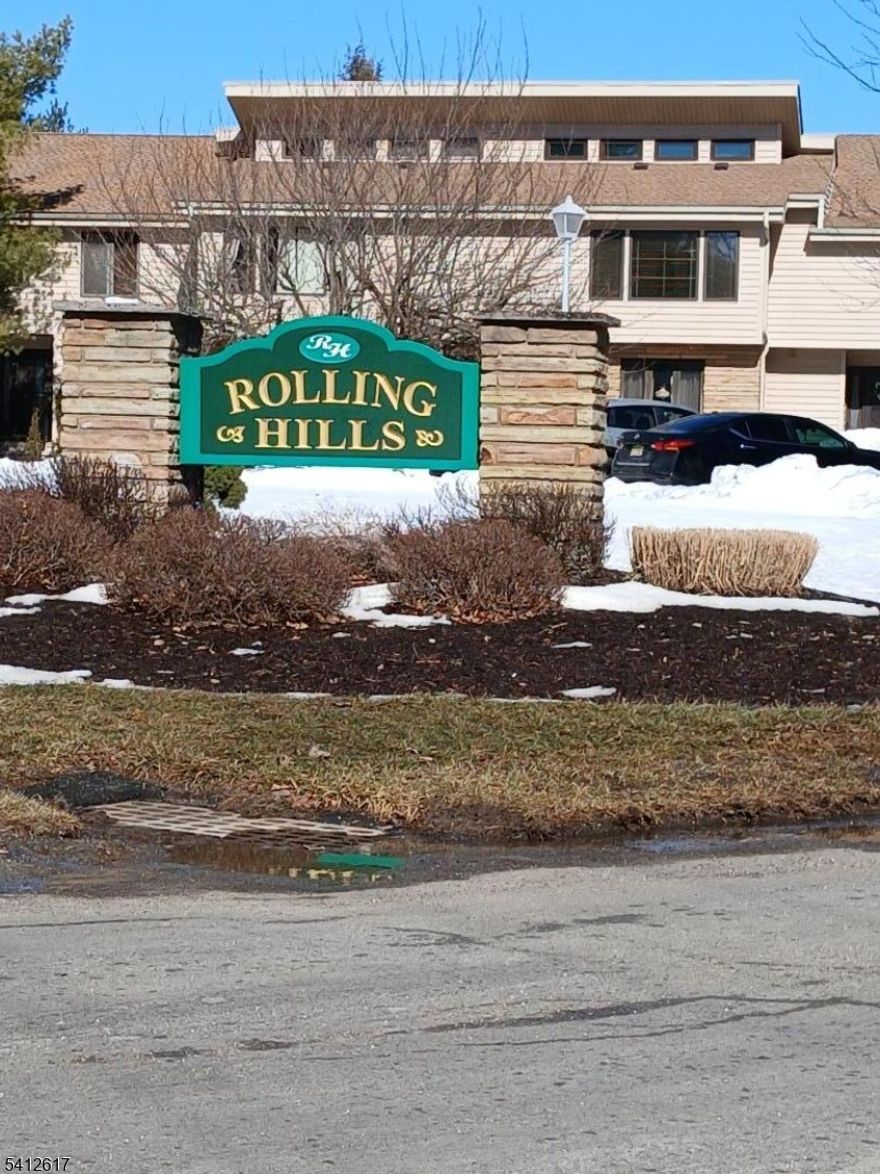 Welcome home to comfort, convenience, and a peaceful setting in the sought-after Rolling Hills community. This beautifully maintained first-floor unit offers easy single-level living with thoughtful updates throughout. The spacious one-bedroom layout features a large kitchen with maple cabinetry, a newly renovated bathroom, and all appliances included for your convenience, along with a hook up for stackable washer and dryer right in the unit. Newer flooring and fresh paint give the home a clean, modern feel. Sliders off the living room/dining room combo  lead to a sunroom that has been used as a home office or even a second bedroom, offering flexible space to fit your needs. Located on a quiet cul-de-sac and backing to the woods, this home provides a peaceful backdrop while still being close to everyday conveniences. Residents of Rolling Hills enjoy access to fantastic community amenities including an association pool, tennis courts, basketball courts, and playgrounds. Each unit includes two parking spots, with additional visitor parking available. If you're looking for low-maintenance living in a welcoming community with great amenities, this could be the perfect place to call home.