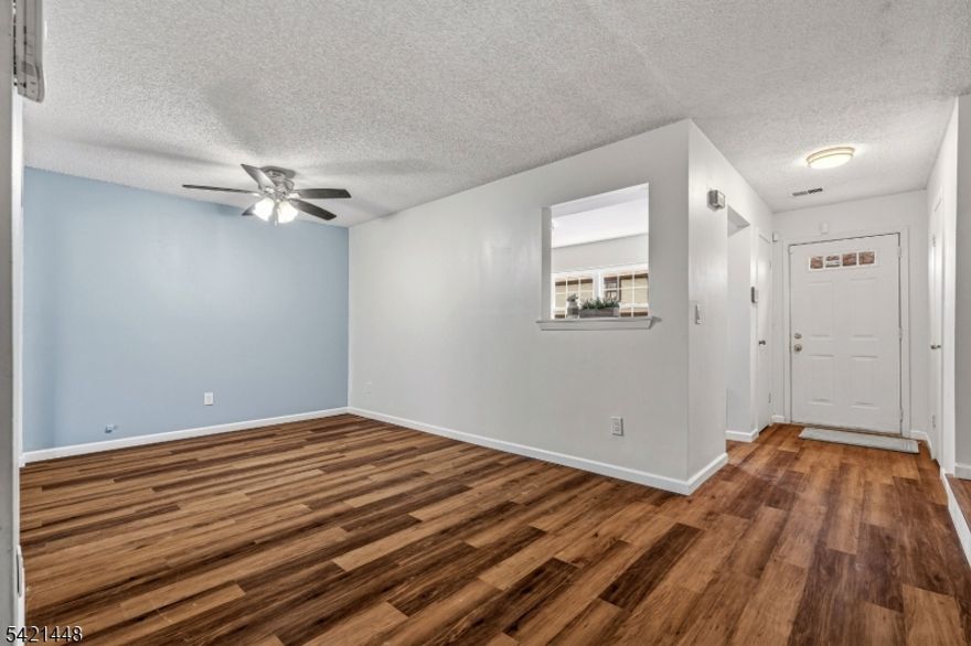 Beautiful freshly painted 2-bedroom, 1.5-bath, two-story townhome featuring luxury vinyl plank flooring throughout, an updated powder room, and a modern kitchen with quartz countertops, cherry raised-panel cabinetry, stainless steel appliances, glass tile backsplash, and new sink and faucet. The open dining and living area boasts a ceiling fan, sliders to a covered patio with storage, and a private, park-like backyard perfect for entertaining. Upstairs offers high ceilings with a skylight, two spacious bedrooms including a primary suite with dual closets and direct access to a full bath with tub/shower and glass doors, plus a convenient laundry closet and ample storage including attic access. Additional highlights include an end-unit location with extra privacy, newer appliances, updated lighting, new outlets and switches, and a furnace closet. Enjoy community amenities including pool, playground, basketball and tennis courts, and clubhouse, all just minutes from NJ Transit trains, major highways, and shopping.