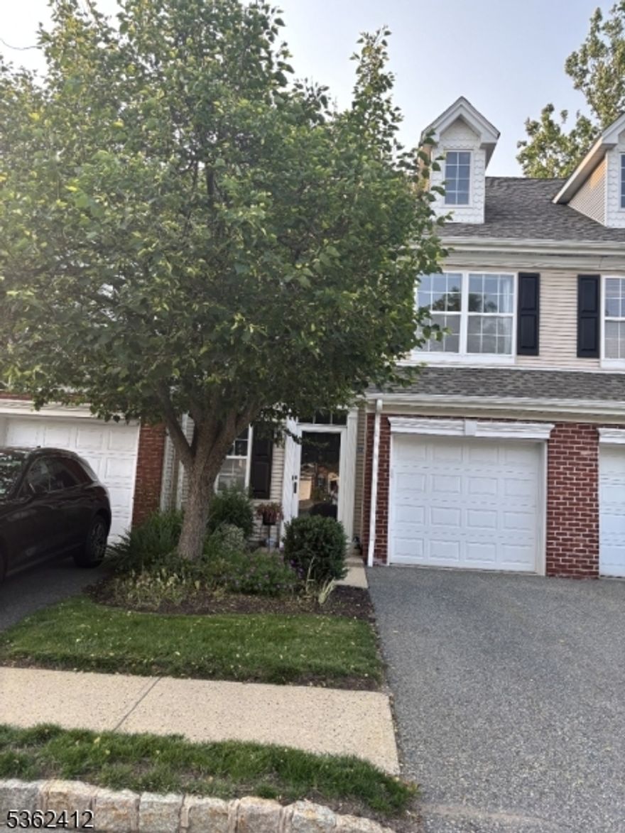 Step into this stylish and sunlit townhome featuring a dramatic two-story living room with expansive windows and a cozy gas fireplace, creating an inviting space for both everyday living and entertaining. The updated kitchen is a chef's delight with granite countertops, stainless steel appliances, and direct access to a private patio that leads to a scenic walking path.The primary suite offers a peaceful retreat with a vaulted ceiling, walk-in closet, and a luxurious en suite bath complete with a soaking tub, separate stall shower, double-sink vanity, and a linen closet. Additional highlights include wood floors in the entryway, dining room, and living room, and a convenient first-floor powder room.Ideally located just minutes from Towaco Town Center, the NJ Transit train to NYC, Route 287, top-rated schools, restaurants, recreation facilities, and the local library this home offers the perfect blend of comfort, convenience, and community.